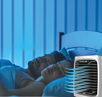 Couple sleeping with Arctic Air® Chill Zone XL cooling the room